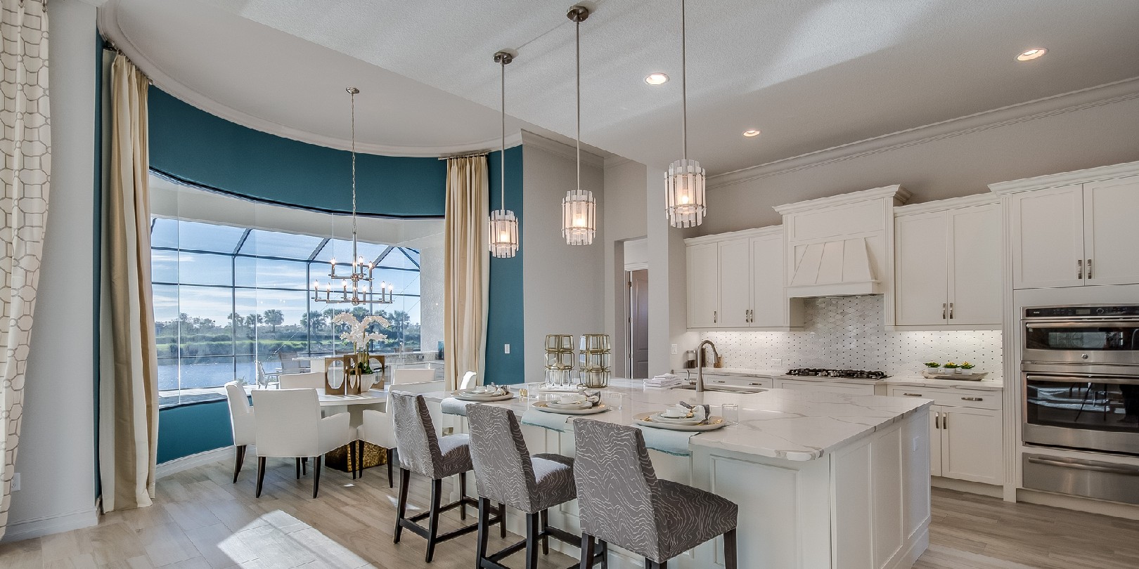 kitchen-island-lighting the-independence Amenities in new kitchen include double oven, wood floor and pendant lighting