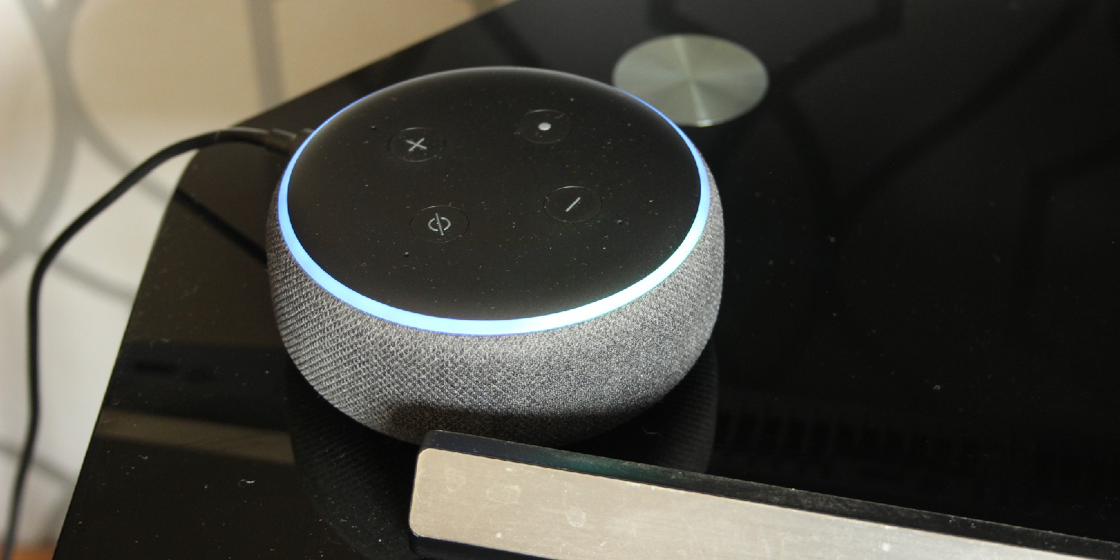 alexa vs google home the-independence Amazon Alexa speaker bluetooth virtual assistant on a tv stand
