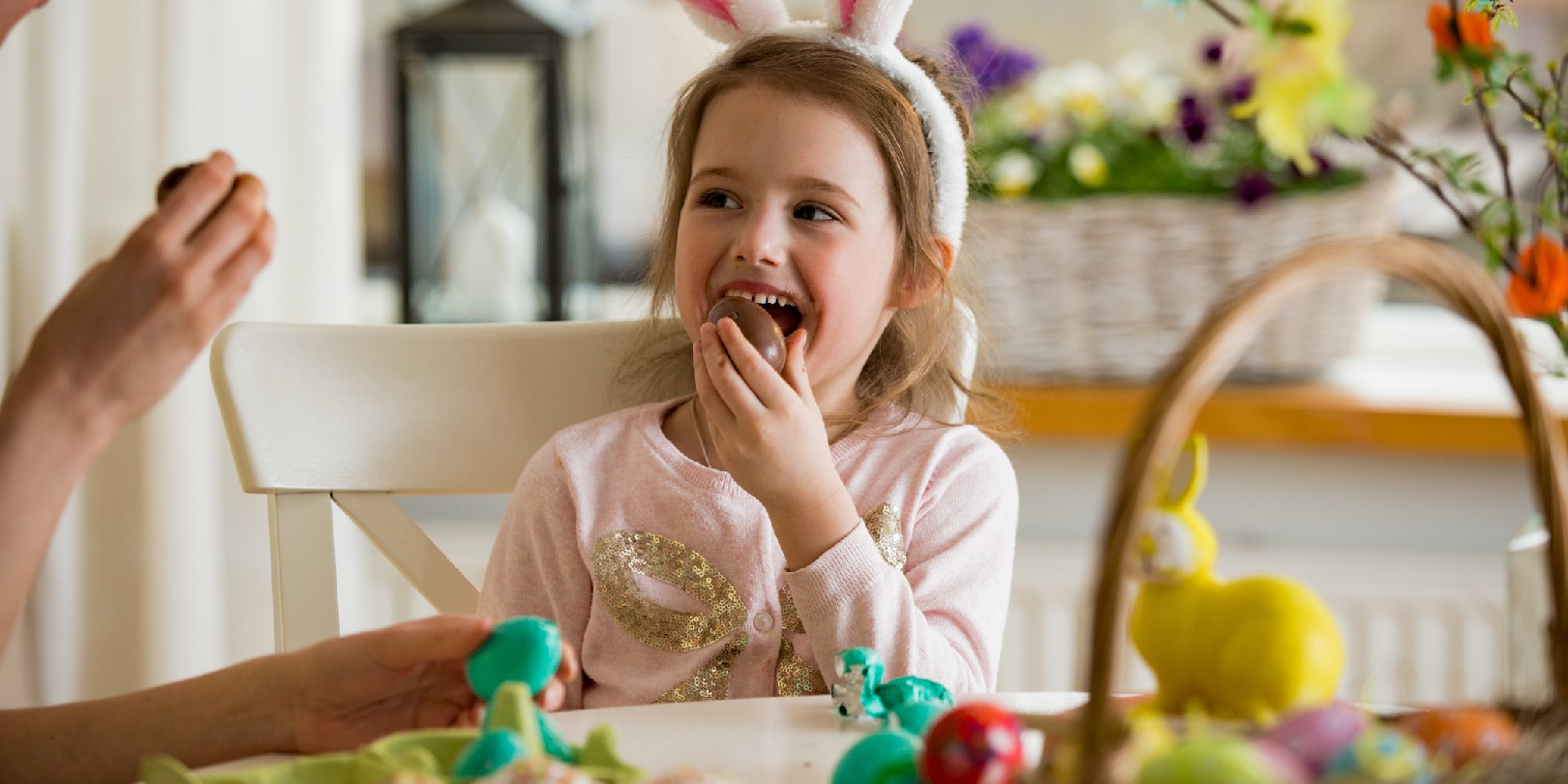easter-movies-for-kids the-independence Mother and daughter celebrating Easter, eating chocolate eggs. Happy family holiday. Cute little girl in bunny ears laughing, smiling and having fun.