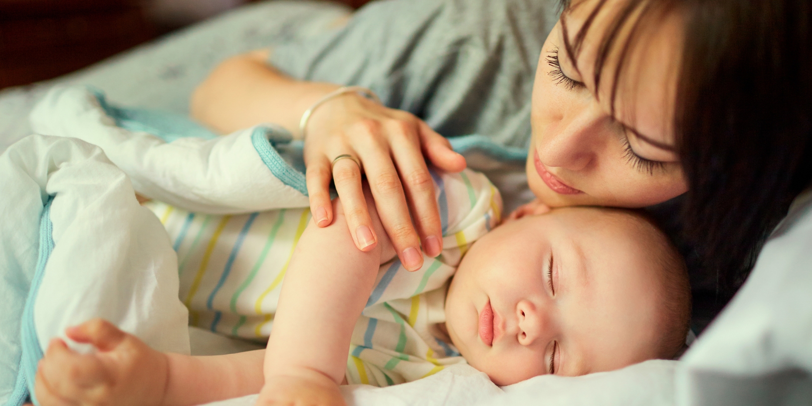 18-month-sleep-regression-the-independence Mother with Sleeping Baby