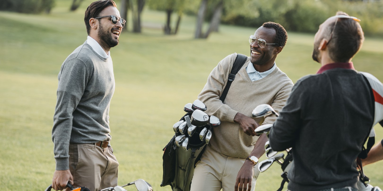 golf-accessories-for-men the-independence multiethnic golf players with golf clubs having fun on golf course